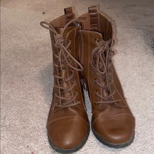 Brown heeled, lace up boots.